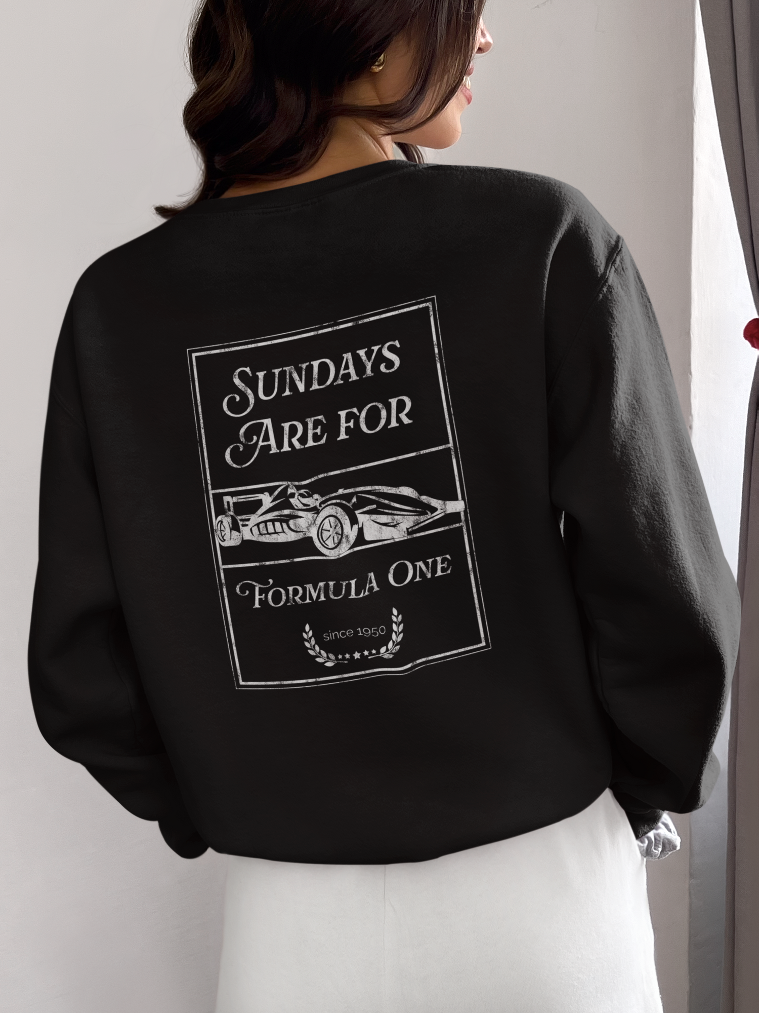 back of woman wearing black sweatshirt with graphic design
