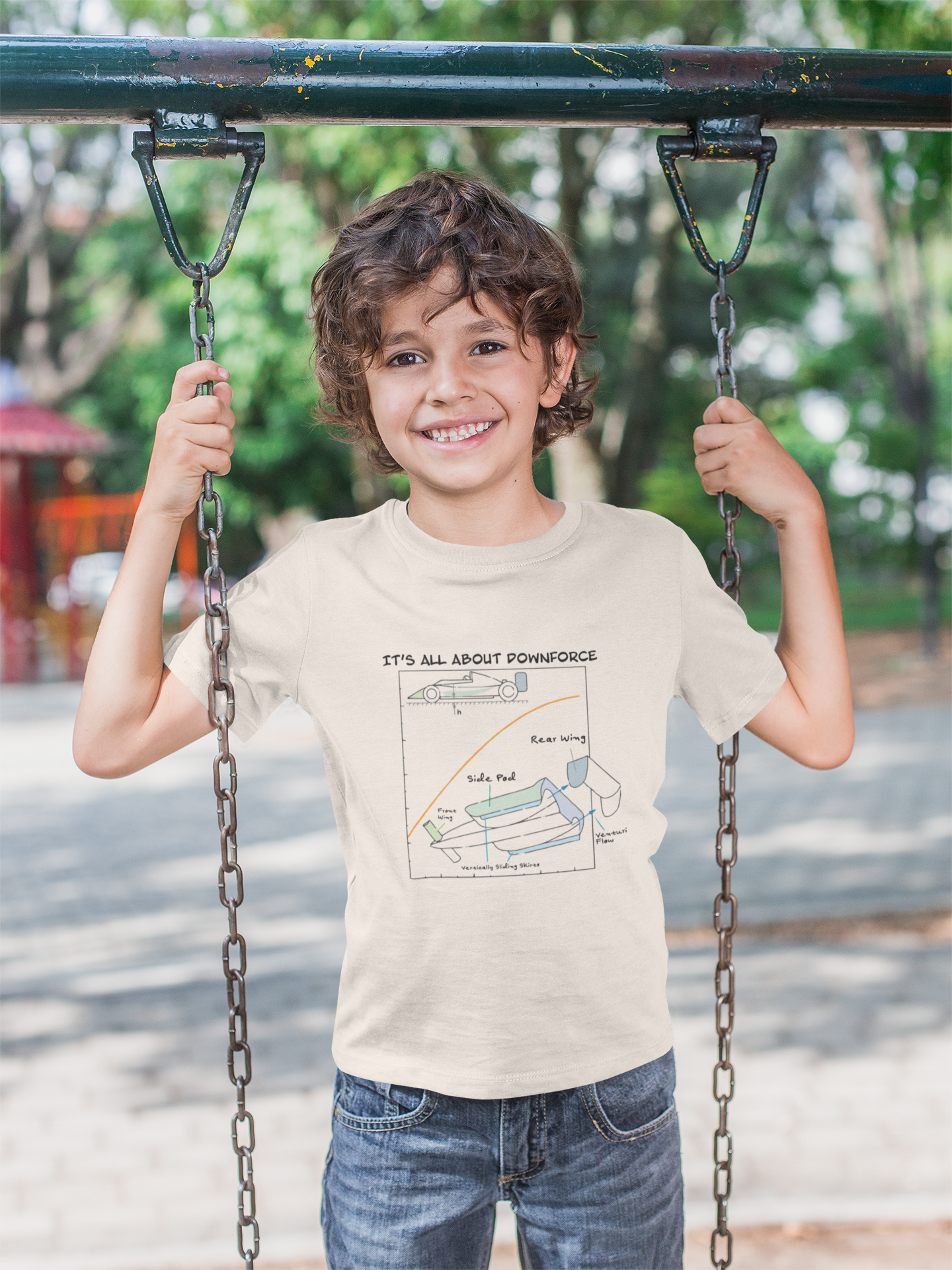 smiling boy on swing showing off stylish t-shirt